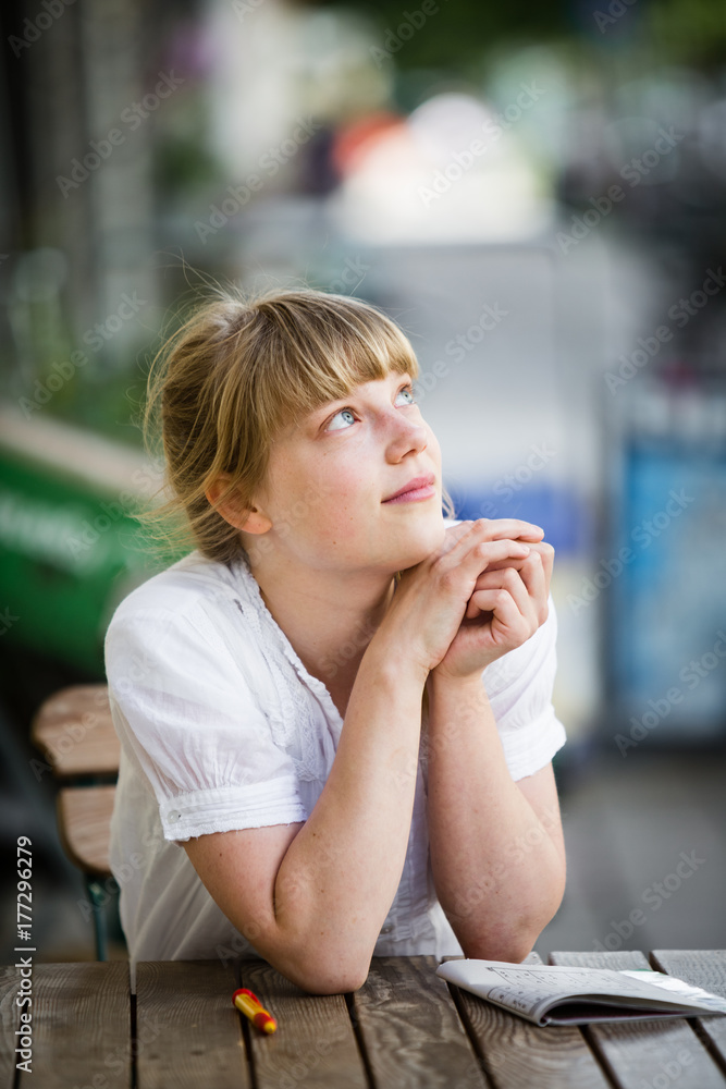 Portrait of an attractive young blonde woman with hands on chin Portrait of an attractive young blonde woman with hands on chin