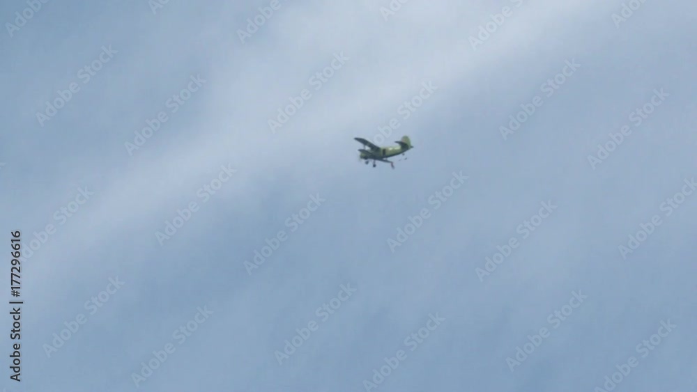 Skydivers jumping from an airplane. White parachute on blue sky background . Skydivers jumping from an airplane. White parachute on blue sky background .