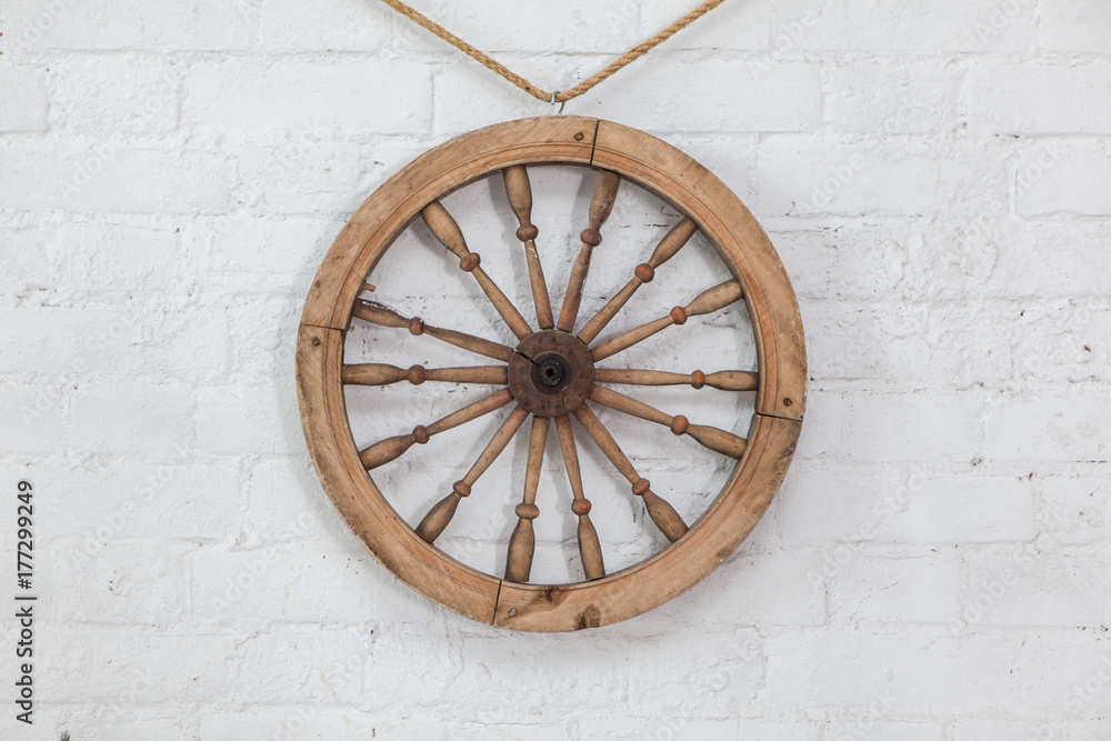 Steering wheel on a white brick wall background