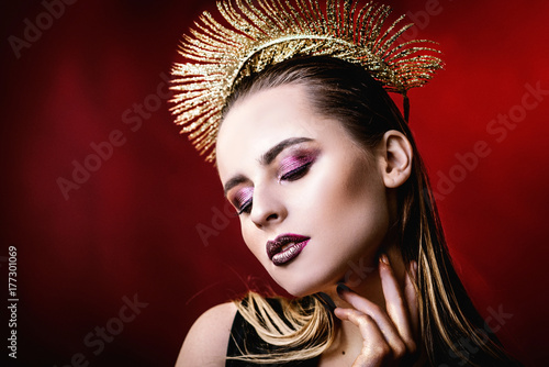 portrait of a girl with a gold crown. Model with creative make-up.