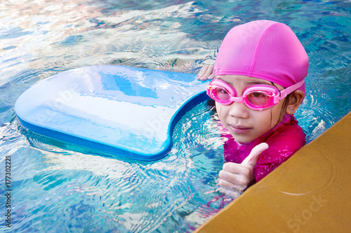 Cute little girl learning to swim
