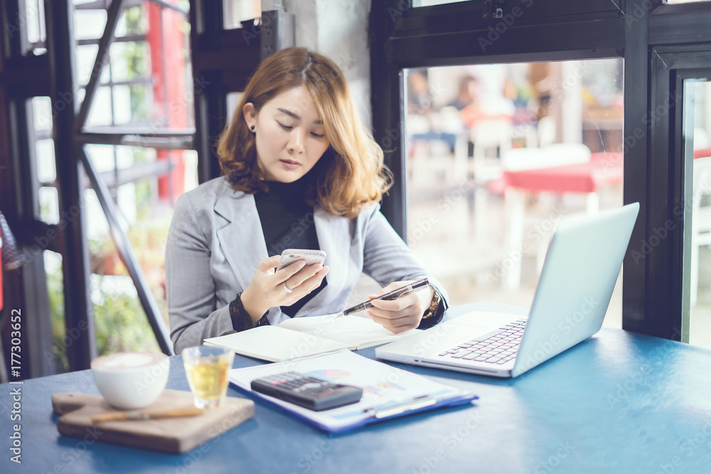 businesswoman working with modern devices, young student using digital tablet computer and mobile smart phone for New marketing plan researching,Paperwork on the table,business concept,selective focus businesswoman working with modern devices, young student using digital tablet computer and mobile smart phone for New marketing plan researching,Paperwork on the table,business concept,selective focus