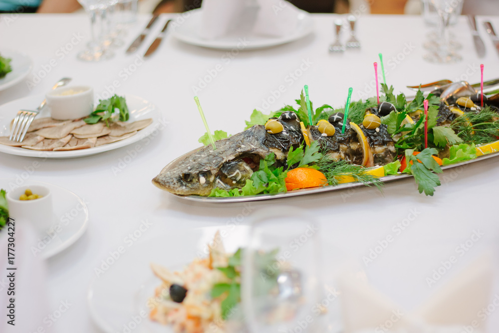 Big fish on table during catering event. Catering buffet. Big fish on table during catering event. Catering buffet.