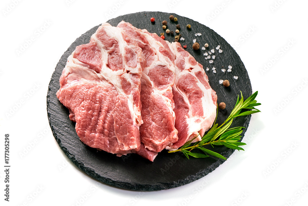 Raw sliced pork meat on stone board, isolated on white background Raw sliced pork meat on stone board, isolated on white background