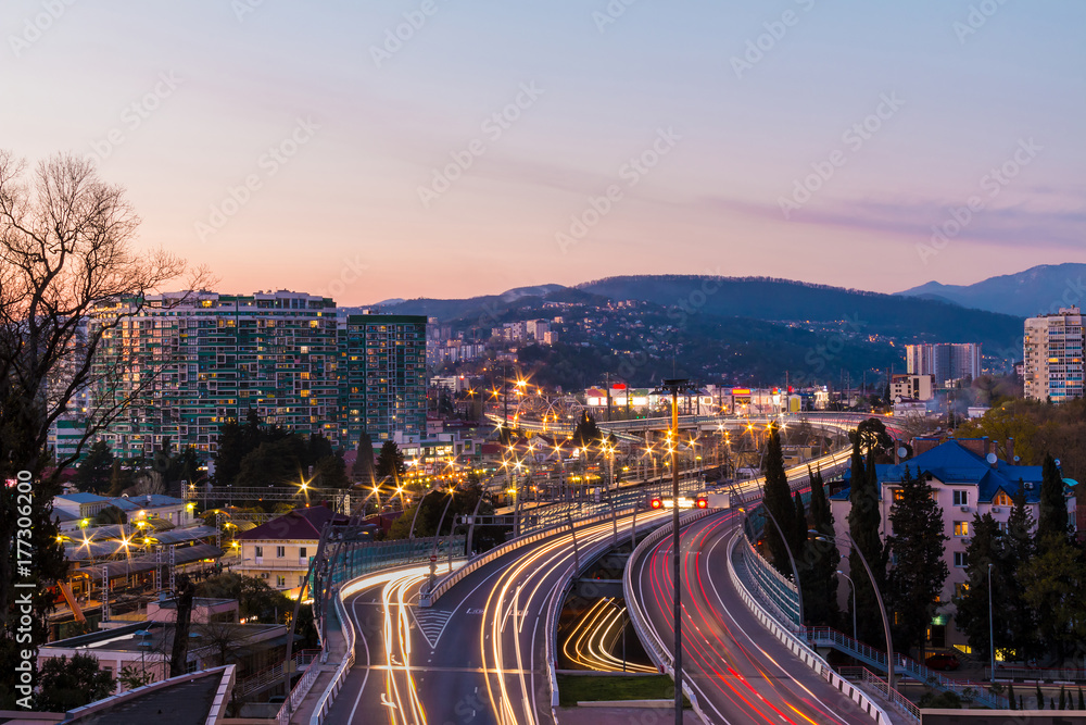 Fototapeta premium Beautiful aerial view of city, mountains and highway 
