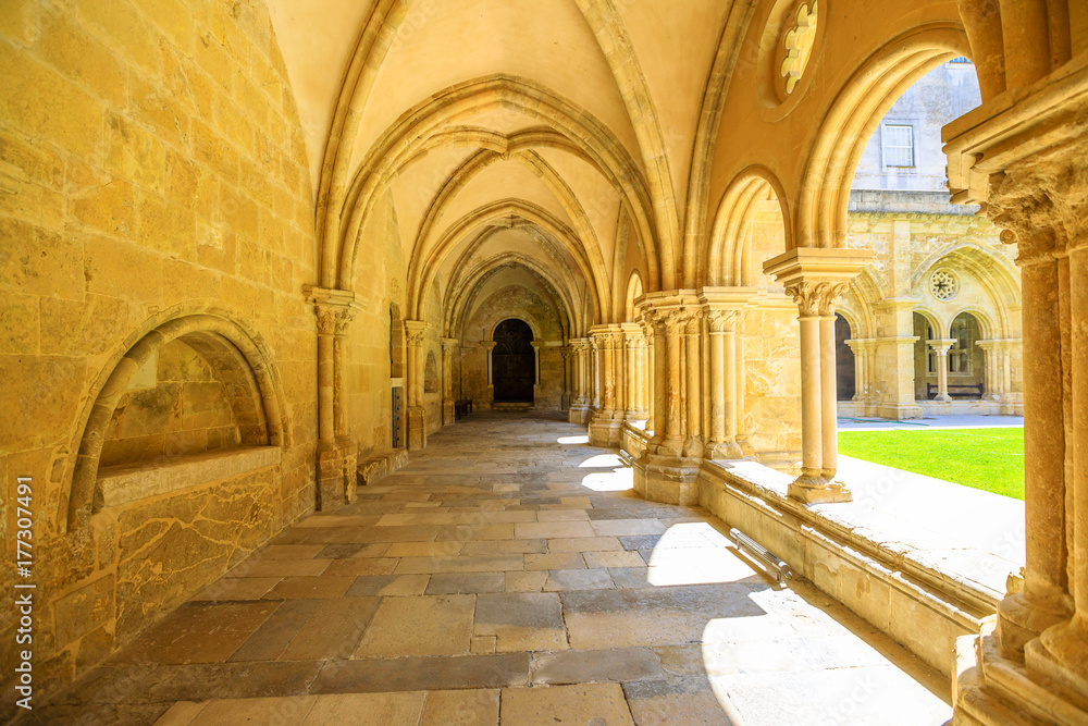 Colonnade of gothic romanesque cloister of old Cathedral of Coimbra. Se Velha de Coimbra, is one of most important romanesque buildings in Portugal and a popular landmark in Coimbra, northern Portugal