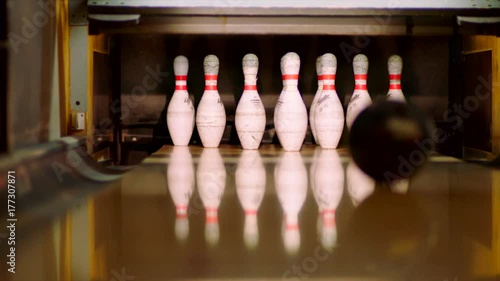 Bowling ball knocking pins on the bowling lane. Slow motion