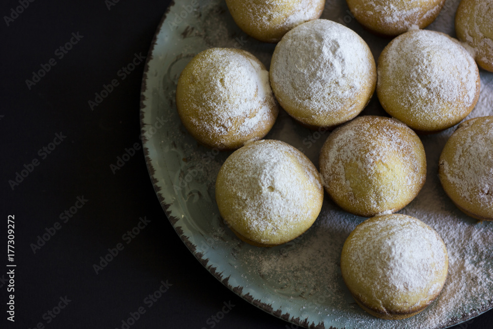 Tasty vanilla muffins on an ornamented plate Tasty vanilla muffins on an ornamented plate