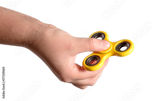 hand holding yellow fidget spinner photo