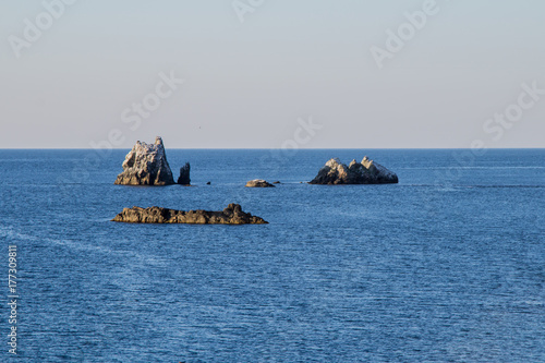 Landscape smooth blue clear water, with rocks photo