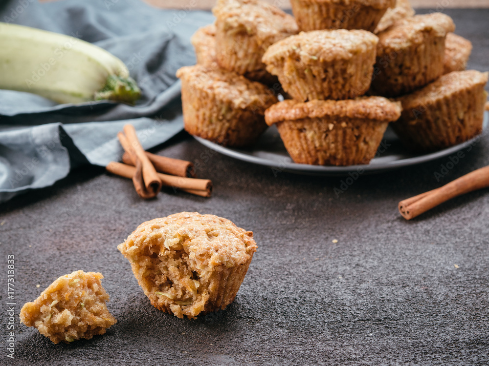 Close up view of muffin with zucchini, carrots, apple and cinnamon on black cement background. Sweet vegetables homemade muffins. Toddler-friendly recipe idea. Copy space. Shallow DOF Close up view of muffin with zucchini, carrots, apple and cinnamon on black cement background. Sweet vegetables homemade muffins. Toddler-friendly recipe idea. Copy space. Shallow DOF