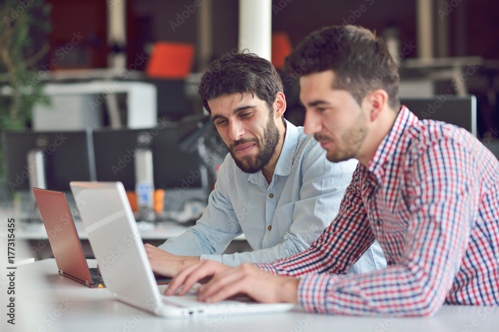 Multiracial contemporary business people working connected with technological devices like tablet and laptop Multiracial contemporary business people working connected with technological devices like tablet and laptop