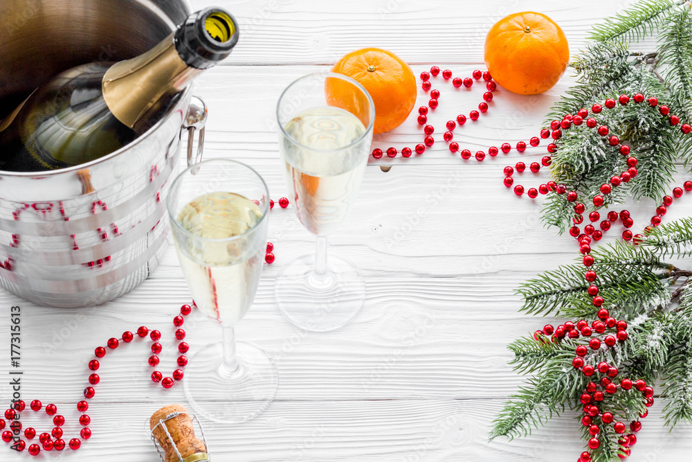 New Year 2018 background. Champagne in bucket, glasses with beverage, tangerines and decoration on grey background copyspace