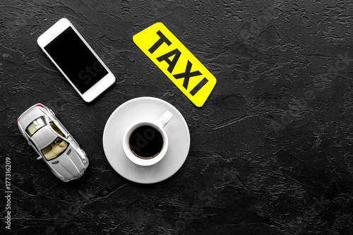 Order taxi online by mobile phone. Black background top view copyspace