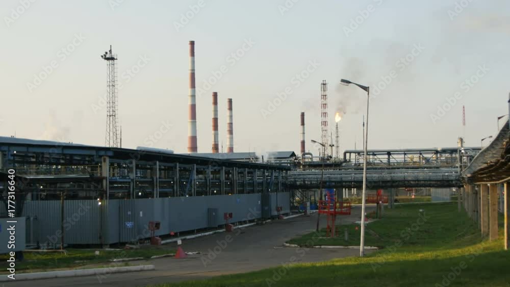 View Gas and Oil Refinery Plant and Flame Torch in Background View Gas and Oil Refinery Plant and Flame Torch in Background