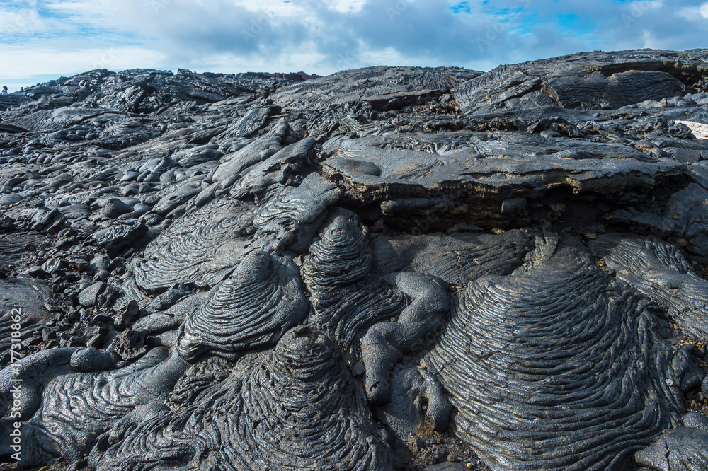 Pahoehoe or rope lava, on Rabida Island, Galapagos. It is formed of igneous  rock, which create bizarre patterns as it cools known as lava sculpture.  Photos | Adobe Stock
