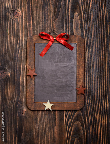Vintage empty chalkboard with christmas decoration and on wooden background