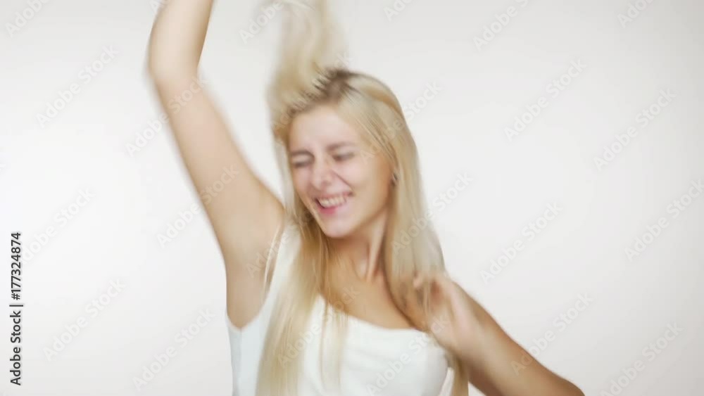 excited cute young woman with long blond hair feeling happy and succeed clenching fist like winner over white background. Concept of emotions excited cute young woman with long blond hair feeling happy and succeed clenching fist like winner over white background. Concept of emotions