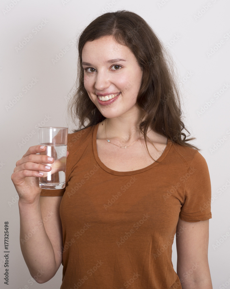 young woman holding a glass of water young woman holding a glass of water