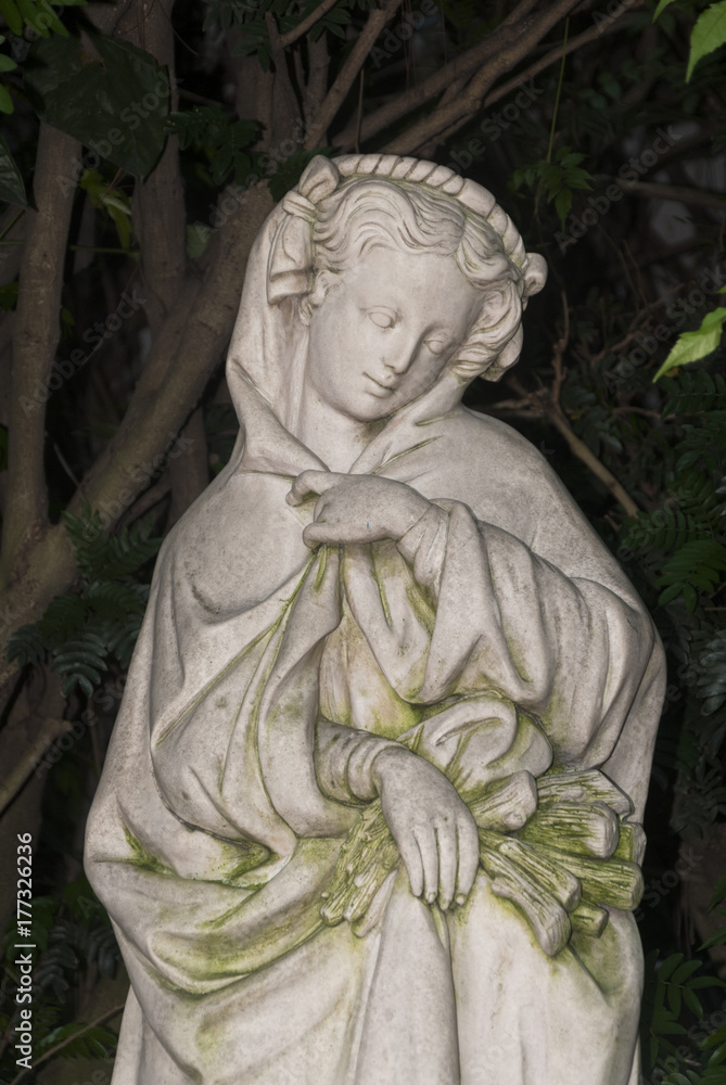 Sculpture of woman in tropical garden, art expression in exterior guatemala.