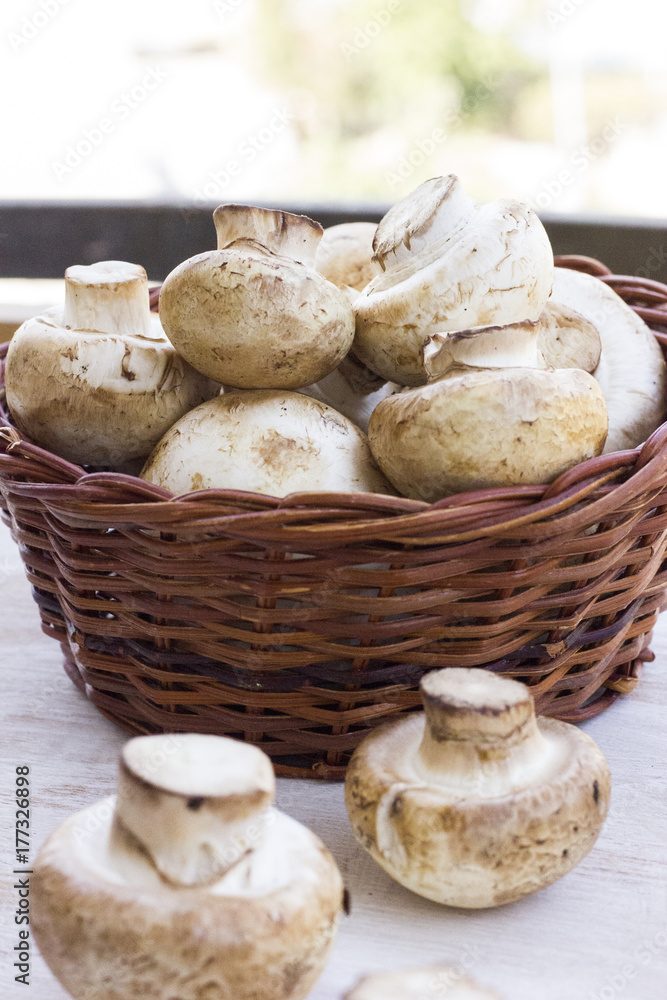 fresh mushrooms in a basket on the wooden table. fresh mushrooms in a basket on the wooden table.