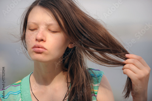 Pretty woman from Volgograd on the shore of the great Russian river Volga inflates her lips and shows her beautiful hair photo