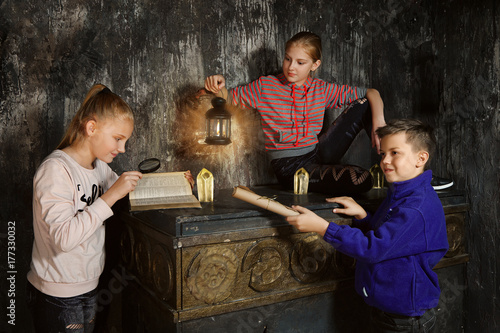 Photography Three children in quest game solving a riddle