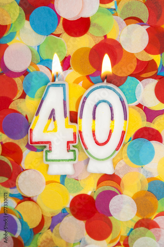 Celebration candle number 40 on a confetti background