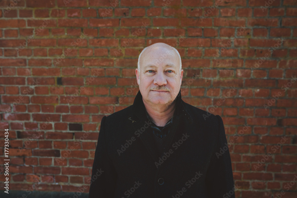 Portrait of content older middle aged man (fifties) outside in winter Portrait of content older middle aged man (fifties) outside in winter