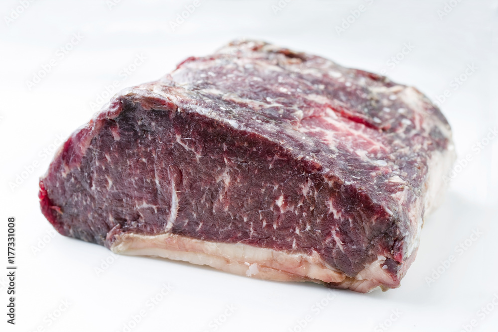 Raw dry aged Kobe roast beef as close-up – covered