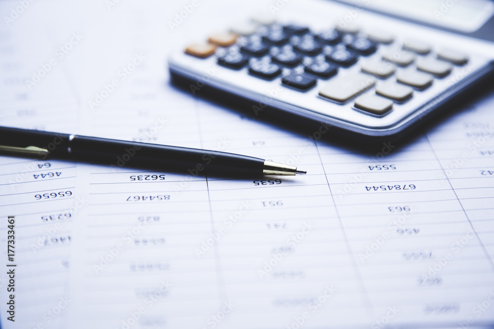calculator and pen on document on table calculator and pen on document on table