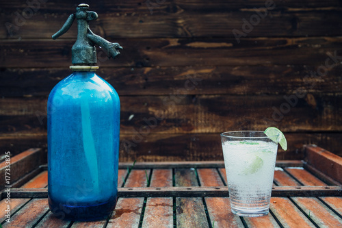 Old Seltzer water aerator bottle and lemonade glass photo
