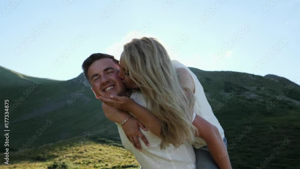 Close-up. Couple doing piggyback having fun, laughing joyful and playful. Close-up. Couple doing piggyback having fun, laughing joyful and playful.