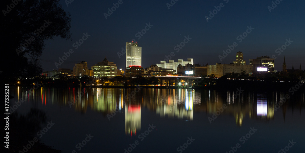 City of Albany lights and reflections on the Hudson River looking from the Renssalear docks in NY
