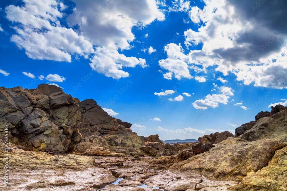 Fototapeta premium The rocky landscape under the sky with clouds, seashore near city of Sozopol in Bulgaria