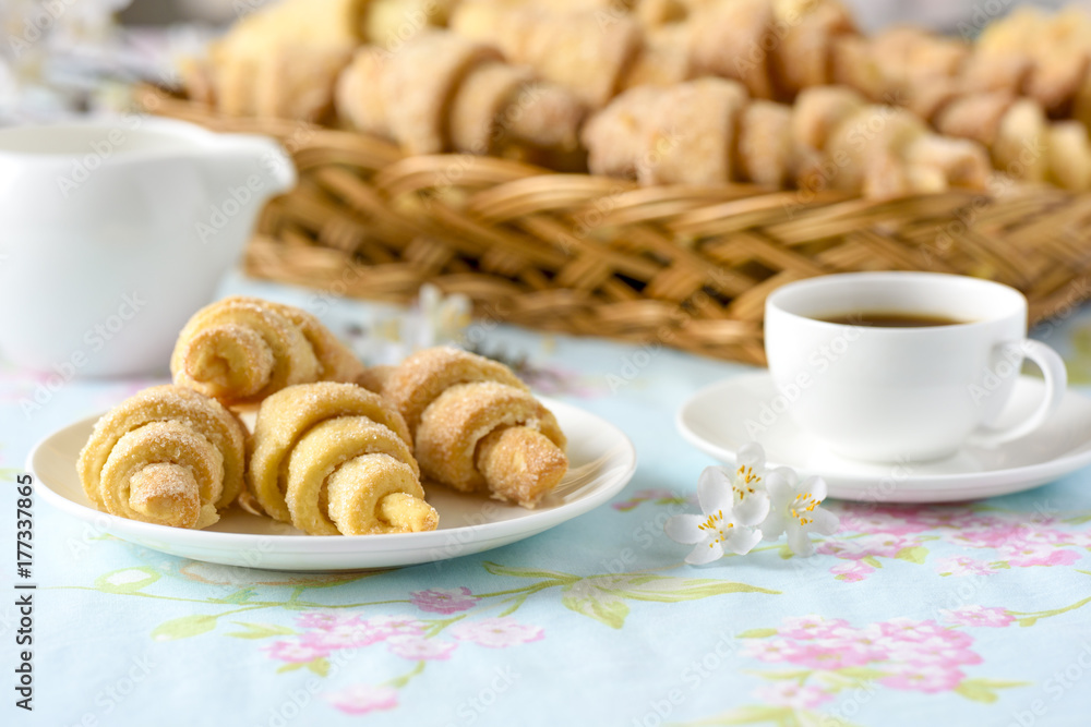 Many croissants on a table with spring flowers Many croissants on a table with spring flowers