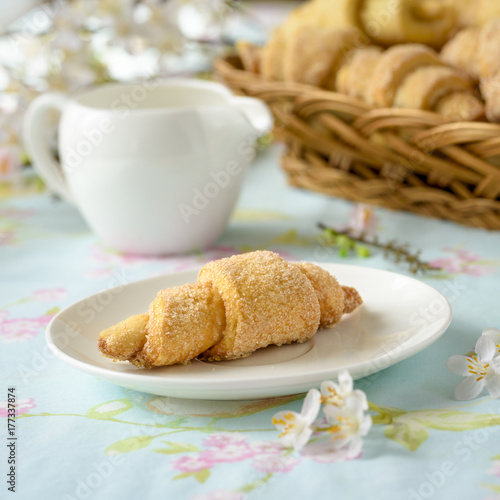 Many croissants on a table with spring flowers