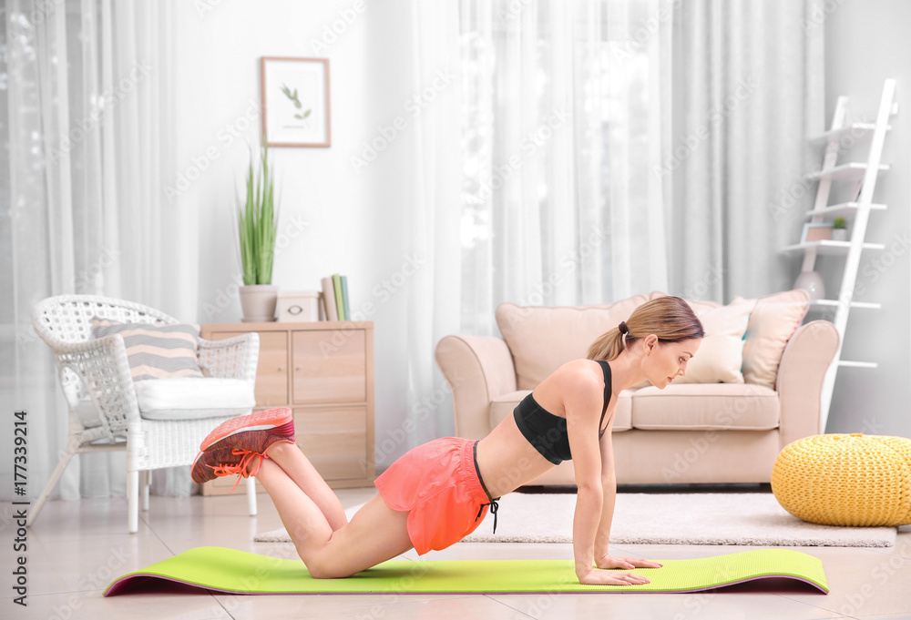 Young beautiful woman training at home Young beautiful woman training at home