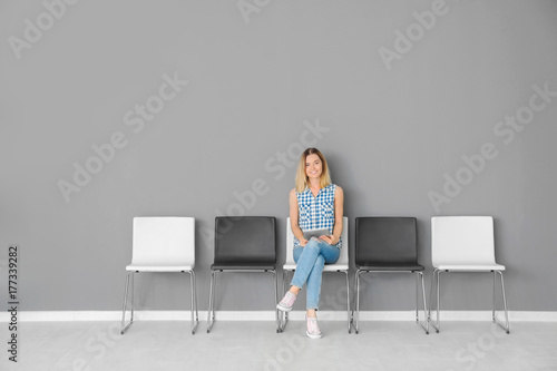 Young woman waiting for job interview in hall