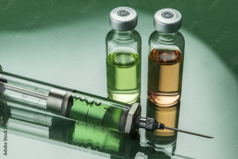 Medicine vials and syringe, conceptual image Medicine vials and syringe, conceptual image