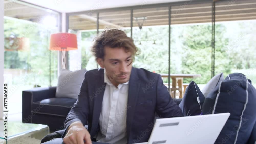 Attractive smartly dressed man with credit card shopping online at home Attractive smartly dressed man with credit card shopping online at home