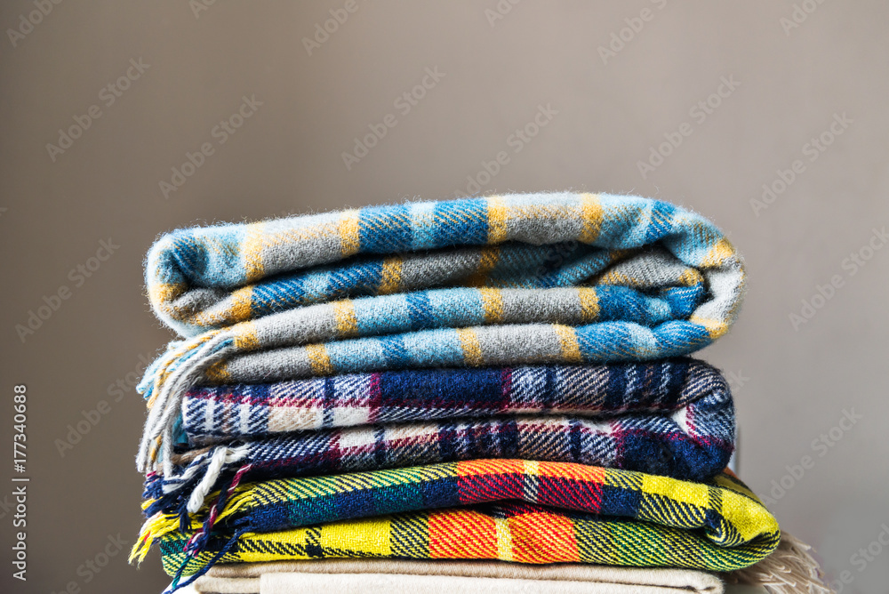 Stack of woolen checked blankets - obrazy, fototapety, plakaty 