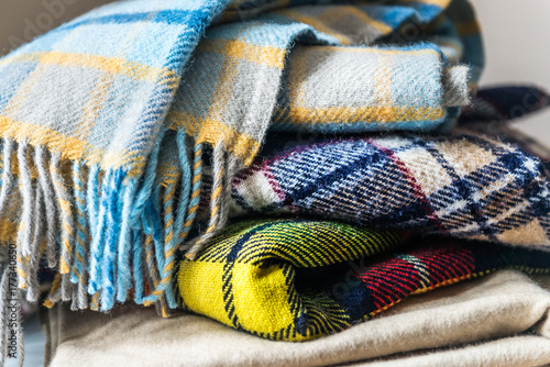 Stack of woolen checked blankets photo
