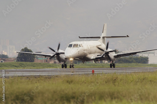 Medium sized propeller passenger plane that has just landed photo