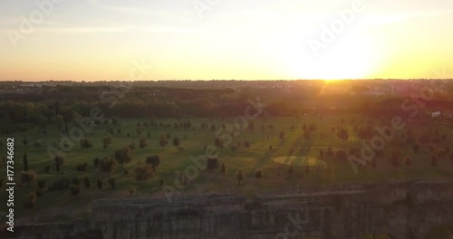 Video from above. Aerial view of the ancient Roman Aqueduct at sunset. Old ruins surrounded by a green public Park (Parco degli Acquedotti) Rome, Italy. photo