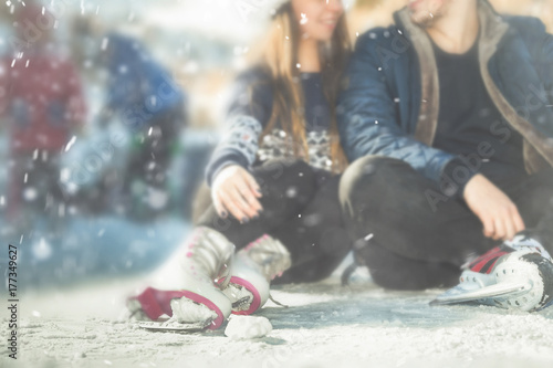 Closeup couple, girls and boy ice skating outdoor at rink