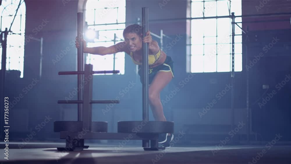  Strong powerful woman doing cross training in urban gym. Super slow motion.