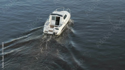 Picturesque panorama - small lonely motor boat sailing along quiet river on sunny warm day