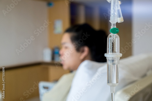 Woman Lying Down In Hospital Bed , patient on the bed with saline drip