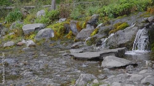 Big beautiful waterfall flows down the rocks mountains photo